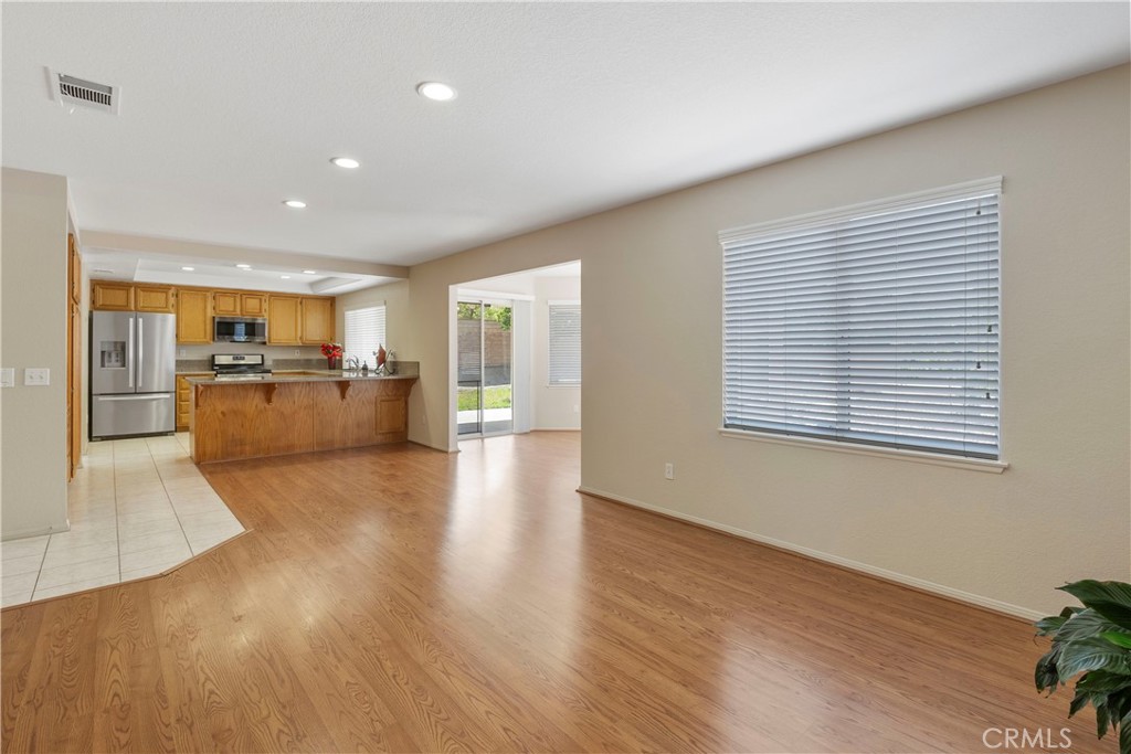 6879 Mission Grove Parkway North Riverside, CA 92506 - Photo 16 of 53 a view of a living room a kitchen with wooden floor and a kitchen