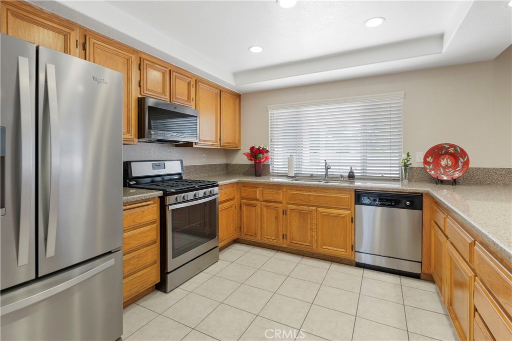 6879 Mission Grove Parkway North Riverside, CA 92506 - Photo 19 of 53 a kitchen with stainless steel appliances granite countertop a stove a sink and a refrigerator