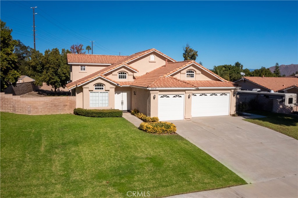 6879 Mission Grove Parkway North Riverside, CA 92506 - Photo 2 of 53 a front view of a house with a yard and garage