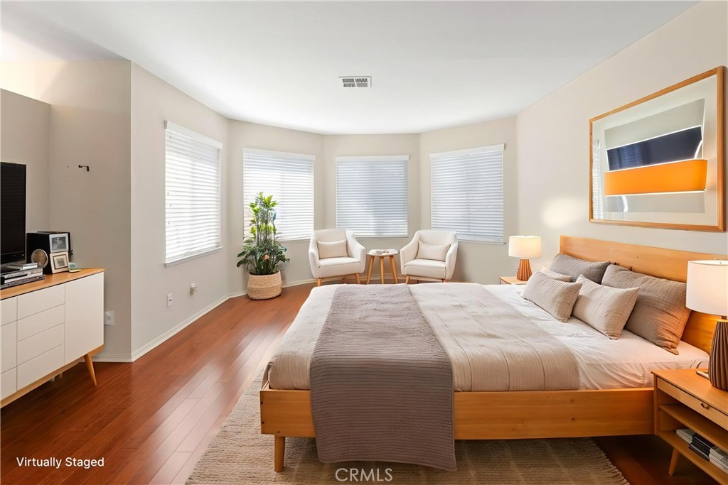 6879 Mission Grove Parkway North Riverside, CA 92506 - Photo 25 of 53 a spacious bedroom with a bed and wooden floor
