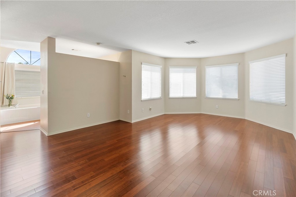 6879 Mission Grove Parkway North Riverside, CA 92506 - Photo 27 of 53 an empty room with wooden floor and windows