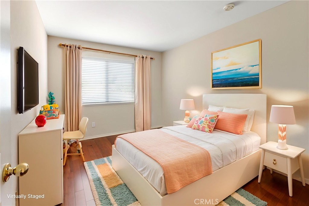 6879 Mission Grove Parkway North Riverside, CA 92506 - Photo 36 of 53 a bedroom with a bed dresser and a flat screen tv