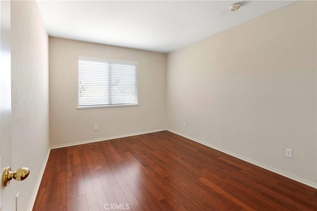6879 Mission Grove Parkway North Riverside, CA 92506 - Photo 37 of 53 an empty room with wooden floor and windows
