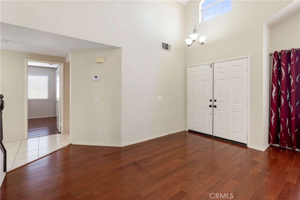 6879 Mission Grove Parkway North Riverside, CA 92506 - Photo 5 of 53 an empty room with wooden floor and a bathroom