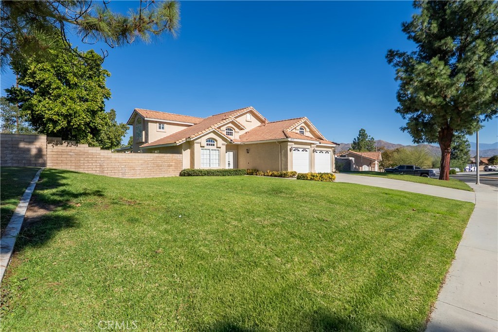 6879 Mission Grove Parkway North Riverside, CA 92506 - Photo 53 of 53 a view of a white house with a big yard and large trees
