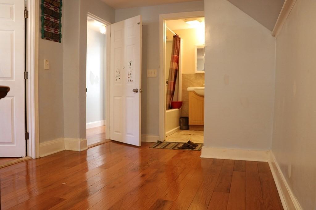 90 Pine Street Swampscott, MA 01907 - Photo 13 of 22 a view of a room with wooden floor and a bathroom