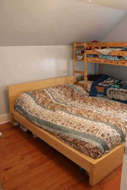 90 Pine Street Swampscott, MA 01907 - Photo 17 of 22 a bed sitting in a bedroom next to a lamp