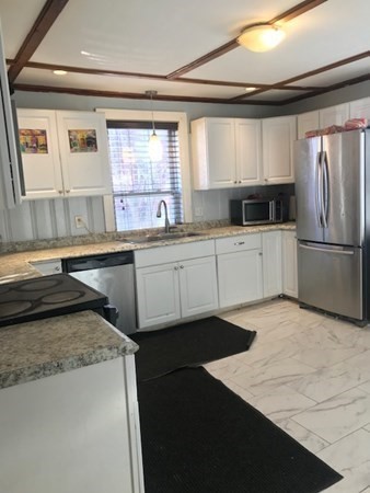 90 Pine Street Swampscott, MA 01907 - Photo 7 of 22 a kitchen with a sink a stove and refrigerator