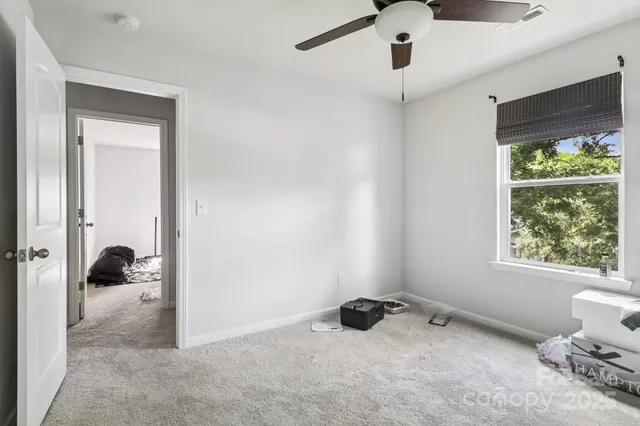 a view of an empty room and a window