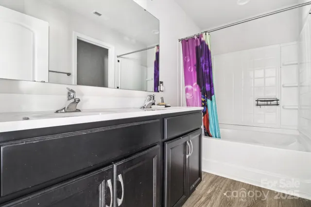 a bathroom with a sink double vanity and a bathtub