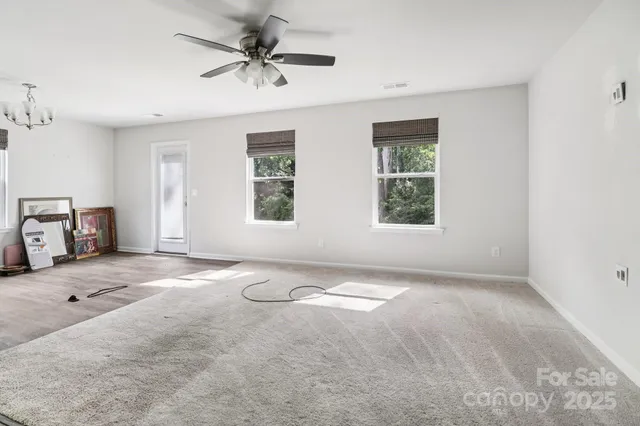 a view of a livingroom with a window and a ceiling fan