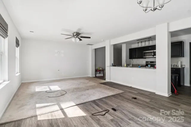 a view of a livingroom with furniture and a kitchen