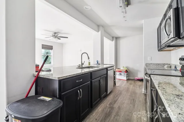 a kitchen with a stove a sink and a refrigerator