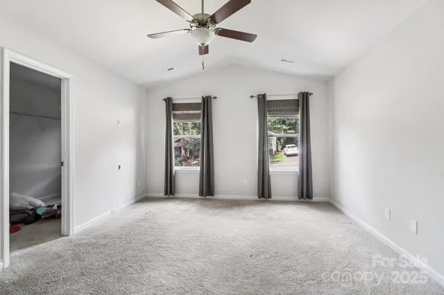a view of a livingroom with a ceiling fan and window