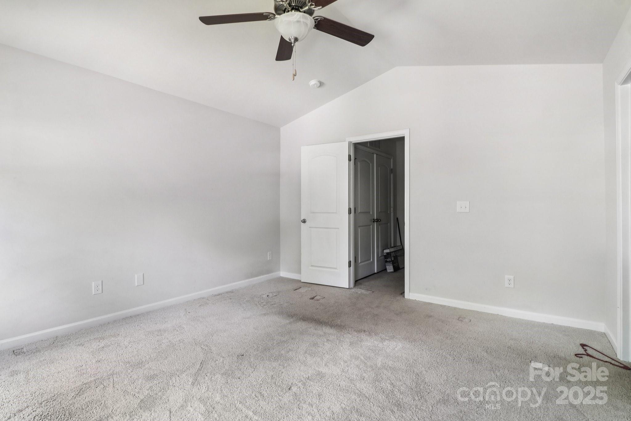 100 South Gregory Street Lancaster, SC 29720 - Photo 9 of 27 an empty room with a ceiling fan and carpet