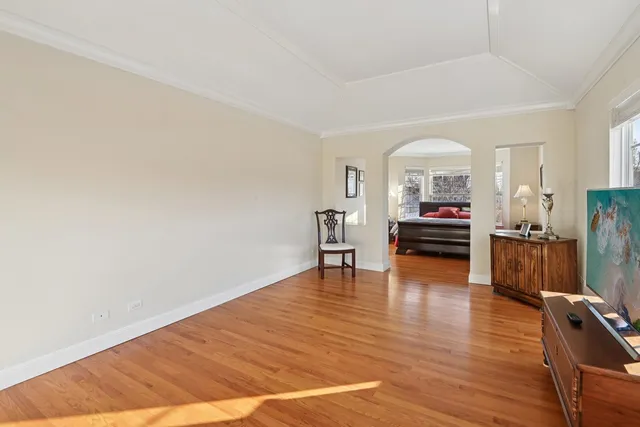 a living room with fireplace furniture and a wooden floor