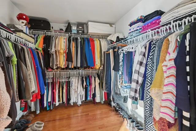 a view of walk in closet with clothes