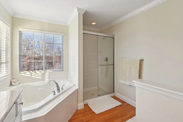 a bathroom with a tub shower and sink
