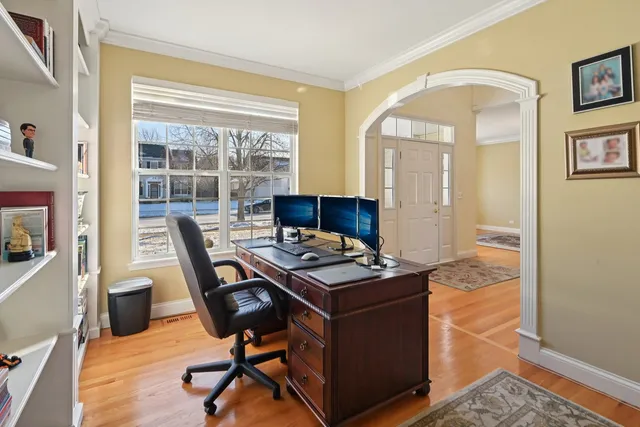 a view of a workspace with furniture and a window
