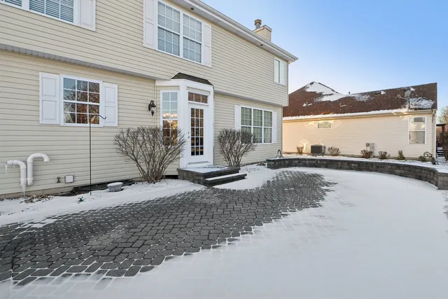 a view of a house with pool and sitting area