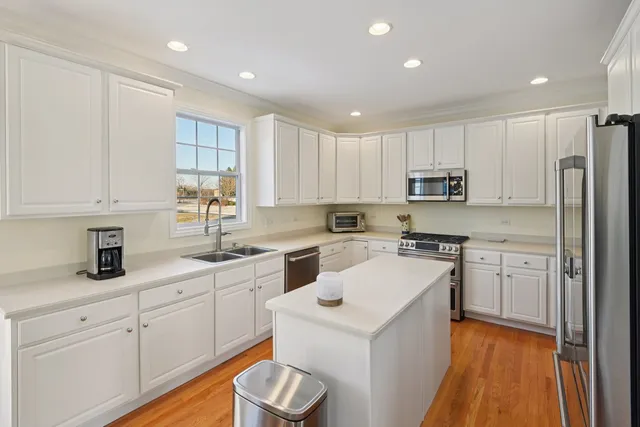 a kitchen with white cabinets and white appliances
