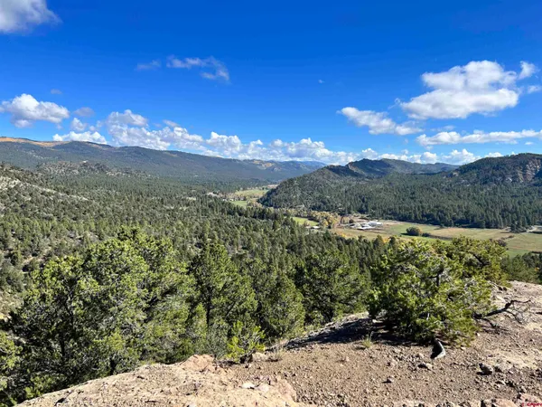 a living room with a large window a table and chairs