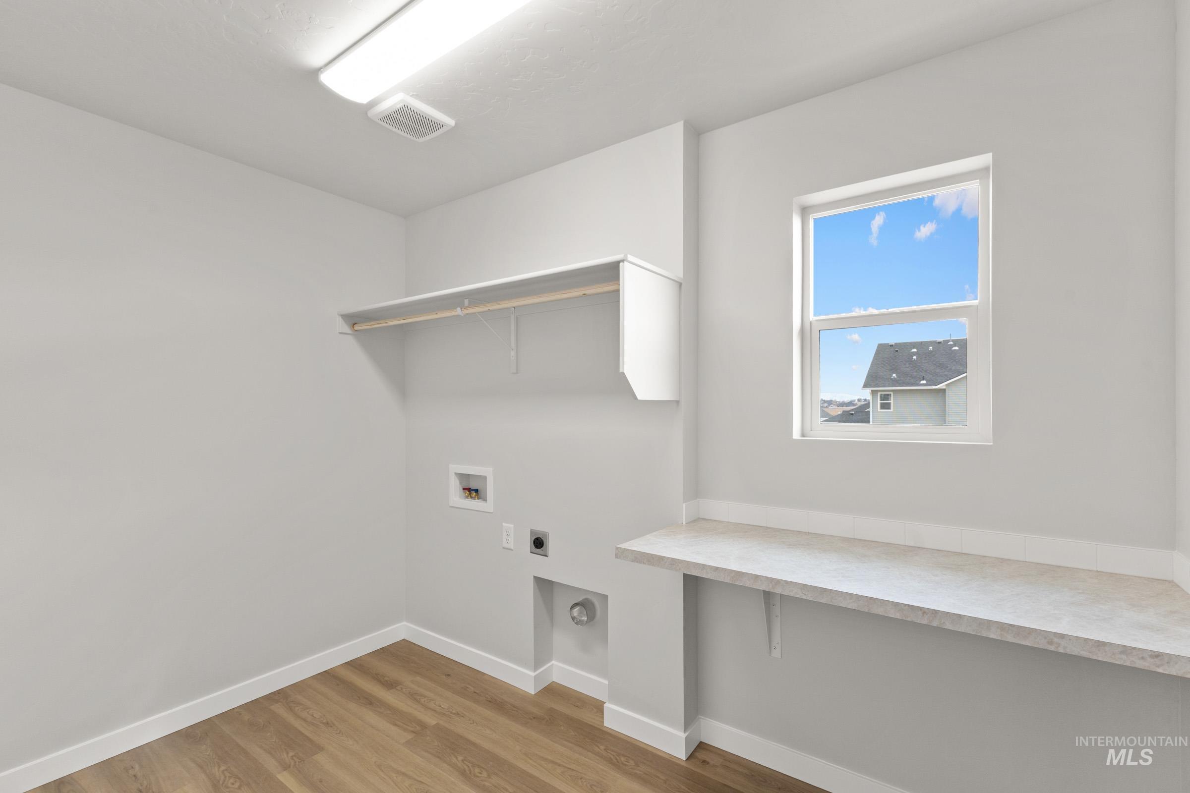 461 Waverly Avenue Middleton, ID 83644 - Photo 16 of 22 Laundry room featuring electric dryer hookup, light wood-type flooring, and washer hookup