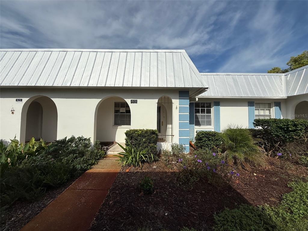4233 Tamargo Drive, Unit 4233 New Port Richey, FL 34652 - Photo 1 of 13 a front view of house with yard and green space