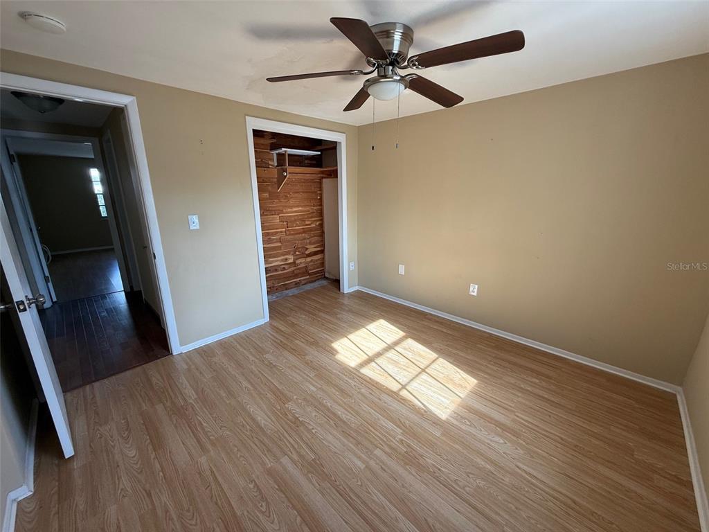 4233 Tamargo Drive, Unit 4233 New Port Richey, FL 34652 - Photo 11 of 13 wooden floor in an empty room with a window