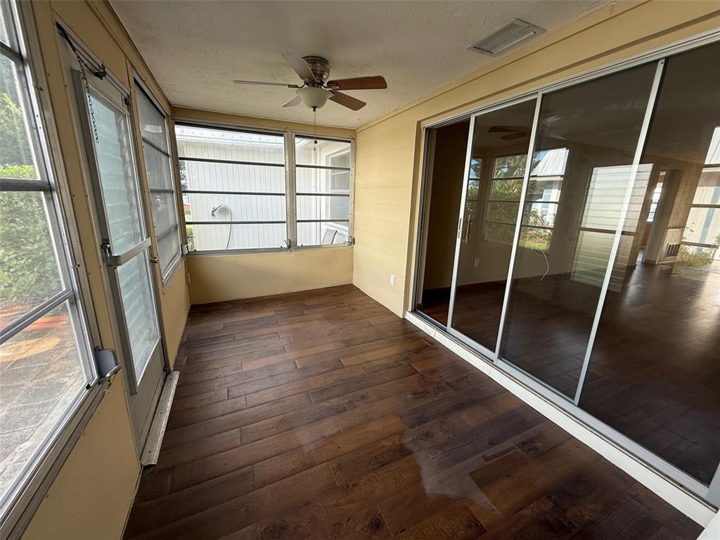 4233 Tamargo Drive, Unit 4233 New Port Richey, FL 34652 - Photo 13 of 13 a view of an empty room with wooden floor and a window