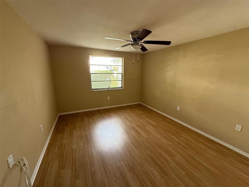 4233 Tamargo Drive, Unit 4233 New Port Richey, FL 34652 - Photo 7 of 13 a view of a room with wooden floor and windows