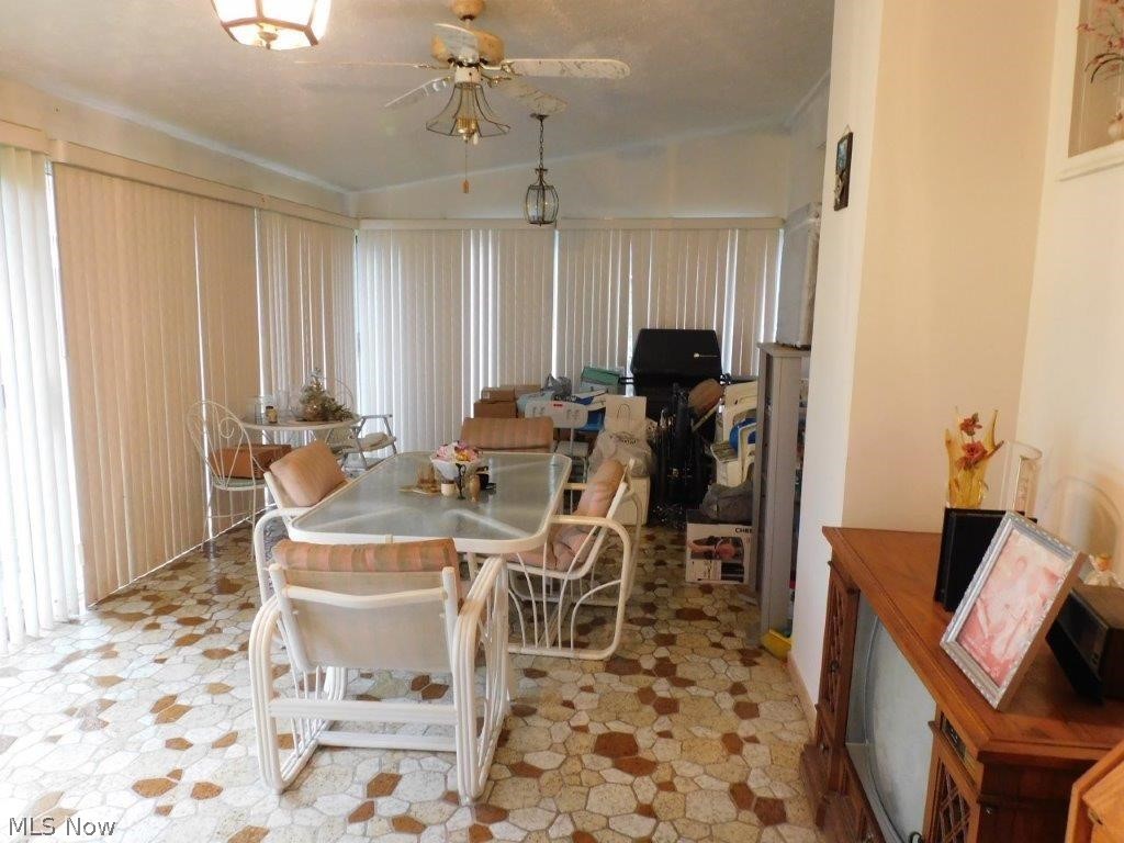 5853 Shepard Road Ashtabula, OH 44004 - Photo 24 of 27 Dining space with light tile floors, ceiling fan, and lofted ceiling