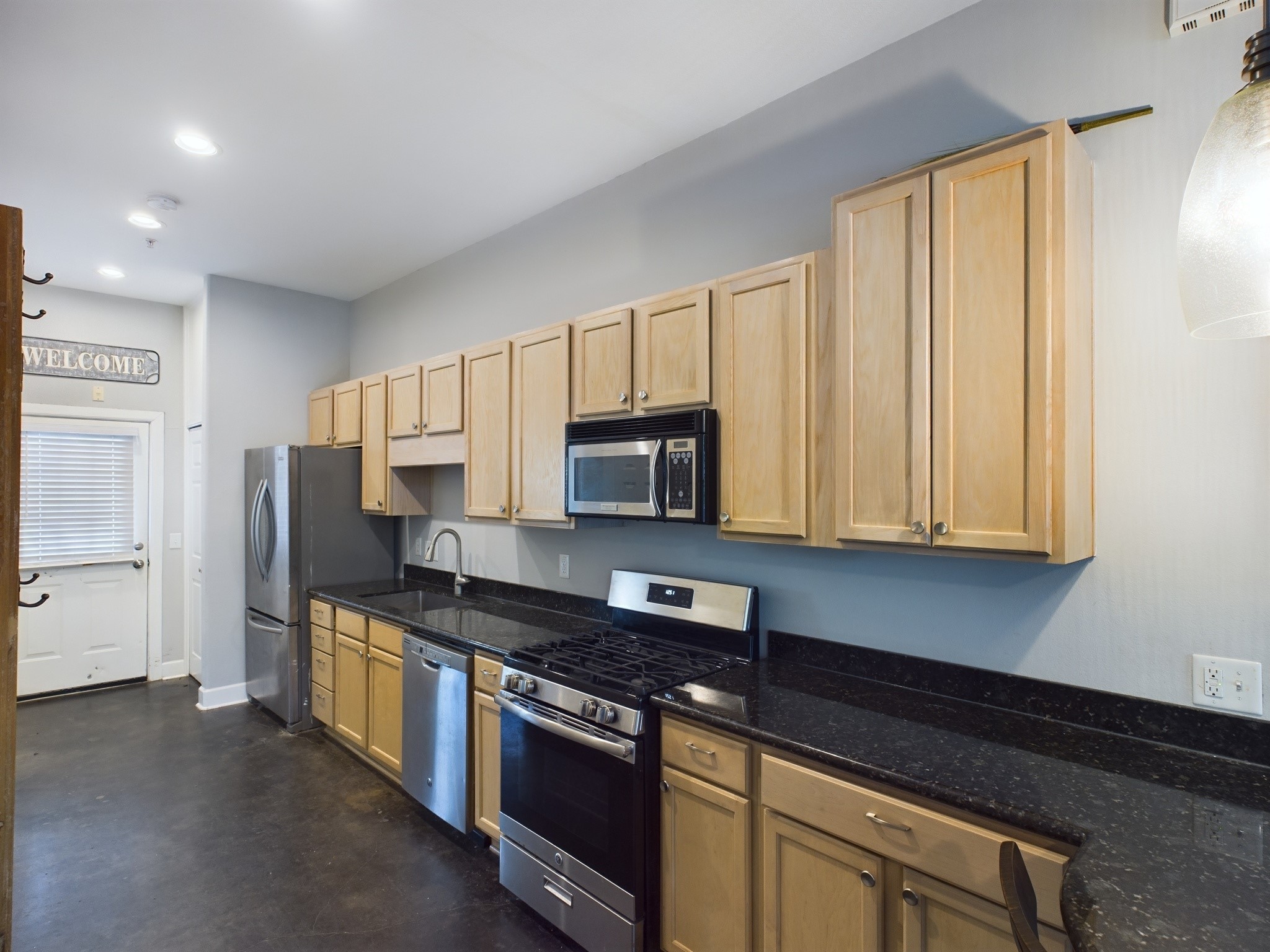 1602 Elgin Street, Unit 3 Houston, TX 77004 - Photo 1 of 10 a kitchen with stainless steel appliances granite countertop a stove a sink and a microwave