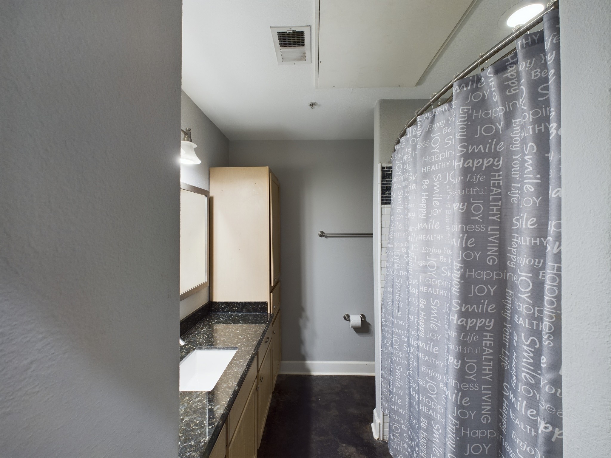 1602 Elgin Street, Unit 3 Houston, TX 77004 - Photo 7 of 10 a bathroom with a granite countertop sink and a mirror