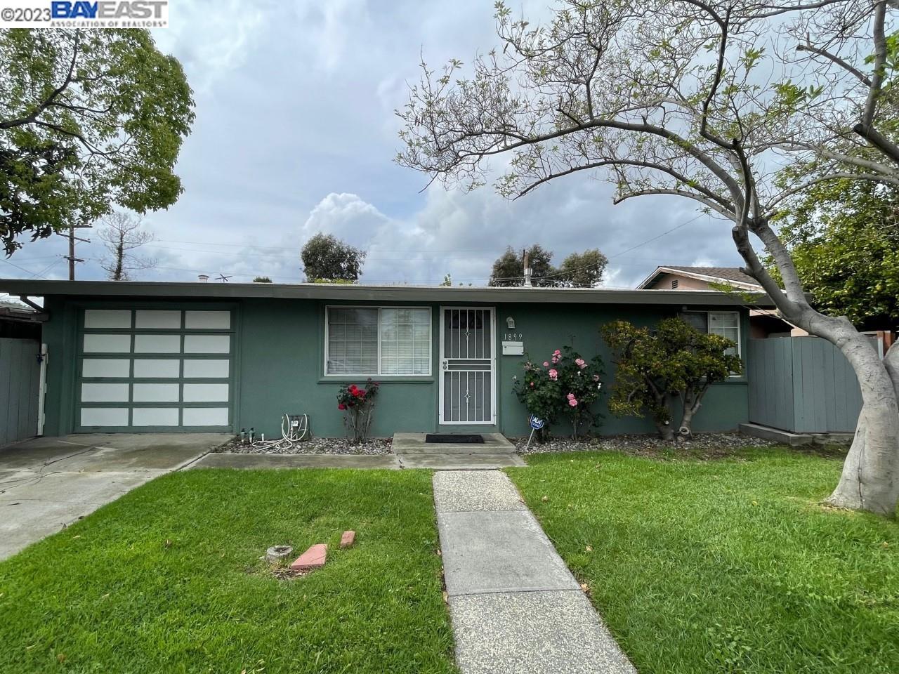 1899 Everglade Avenue San Jose, CA 95122 - Photo 1 of 1 a front view of a house with a garden and plants