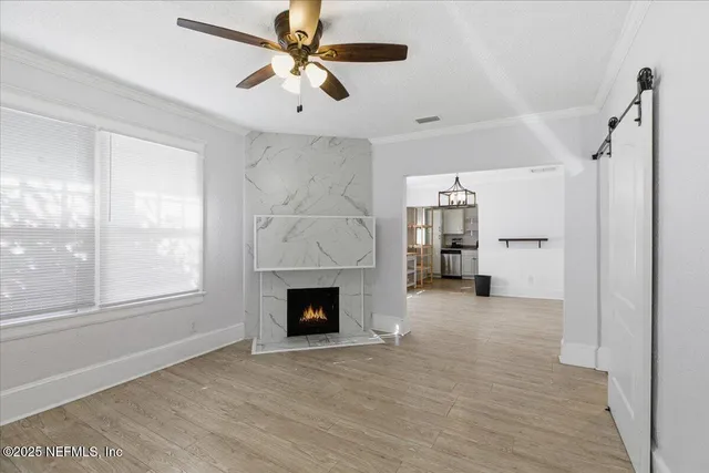 a view of an empty room with a fireplace and a window