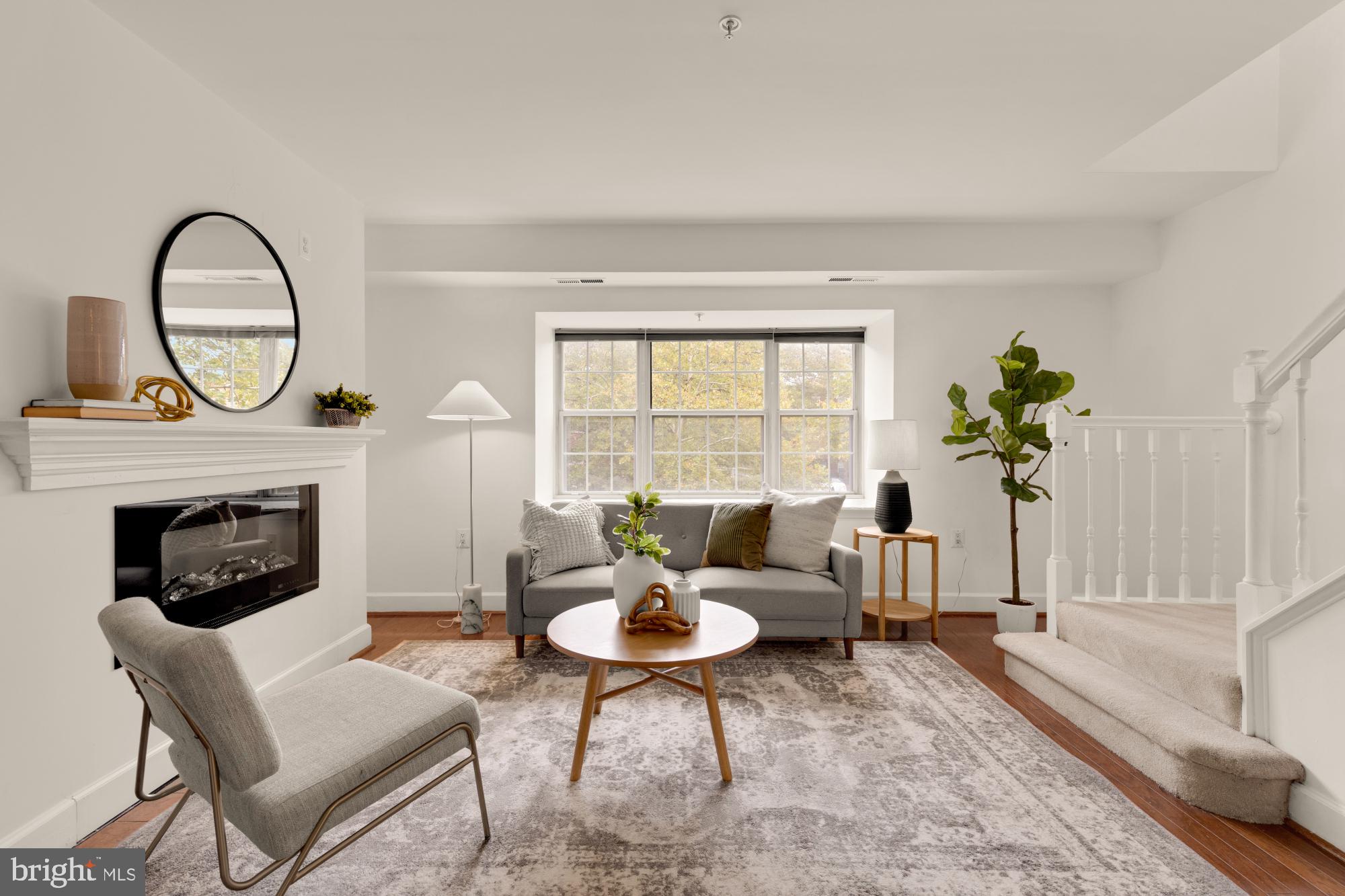 a living room with furniture a window and a fireplace