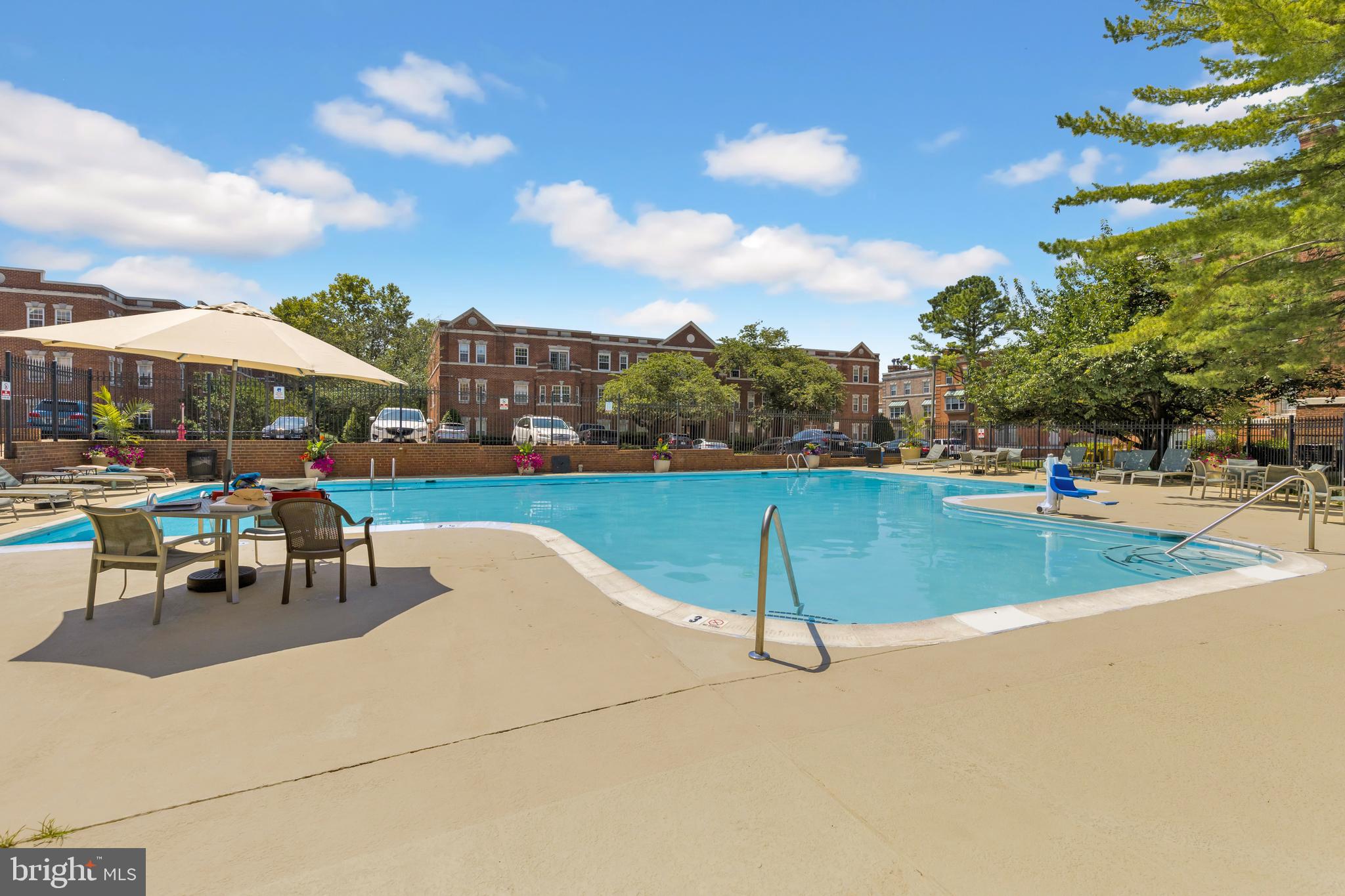 3601 38th Street Northwest, Unit 303 Washington, DC 20016 - Photo 15 of 19 a view of a swimming pool and lounge chairs