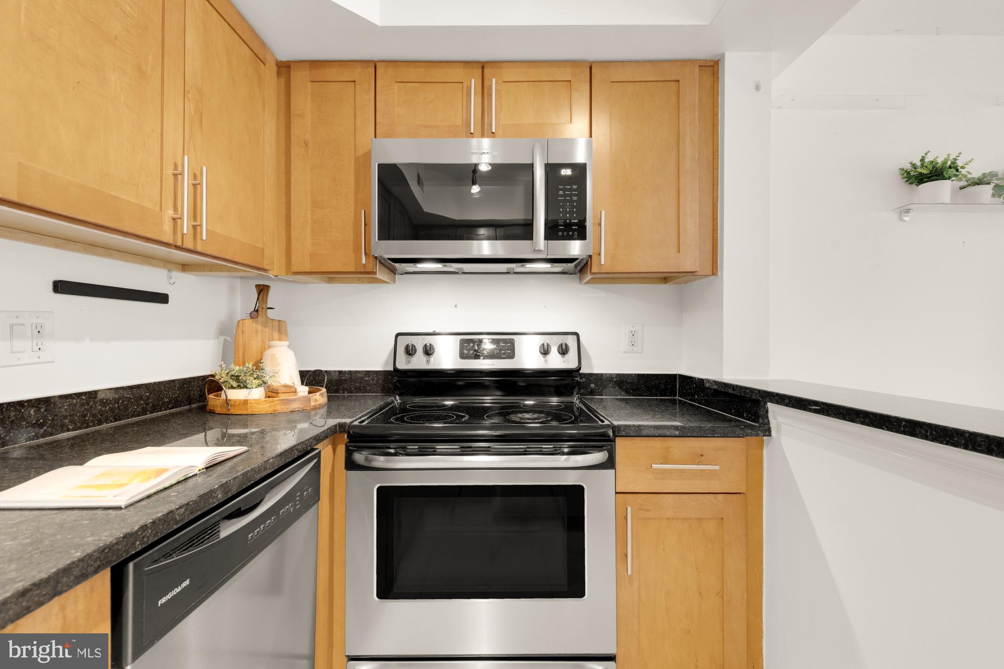 3601 38th Street Northwest, Unit 303 Washington, DC 20016 - Photo 6 of 19 a kitchen with stainless steel appliances granite countertop a stove and a microwave