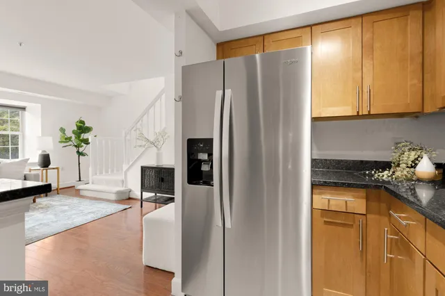 a kitchen with stainless steel appliances granite countertop a refrigerator and a stove top oven