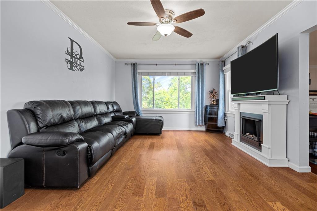 1415 Anderson Road Pittsburgh, PA 15209 - Photo 4 of 25 a living room with fireplace furniture and a flat screen tv