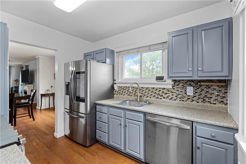 1415 Anderson Road Pittsburgh, PA 15209 - Photo 9 of 25 a kitchen with stainless steel appliances granite countertop a refrigerator sink and cabinets