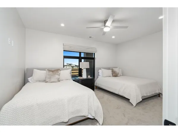 a bedroom with a bed and a large mirror
