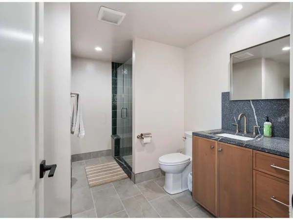 a view of bathroom with a toilet sink and mirror