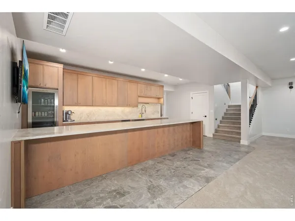 a kitchen with stainless steel appliances granite countertop a refrigerator and a sink