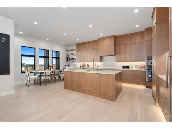 a kitchen with stainless steel appliances kitchen island granite countertop a sink and cabinets