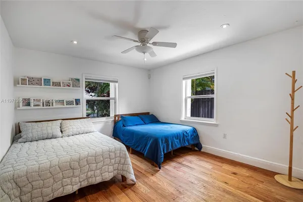 a bedroom with two beds and a window