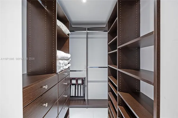 a view of walk in closet with empty racks