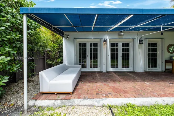 a view of a patio with a table and chairs