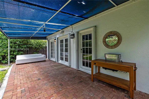 a view of a house with backyard sitting area and garden